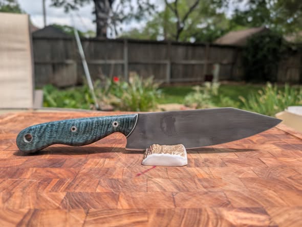 Finished custom knife displayed outdoors