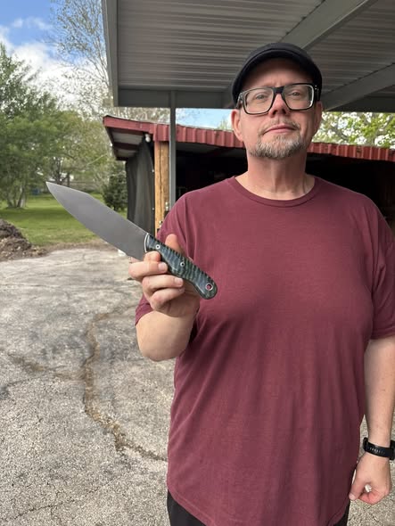 No Quarter Knives maker holding a finished custom knife